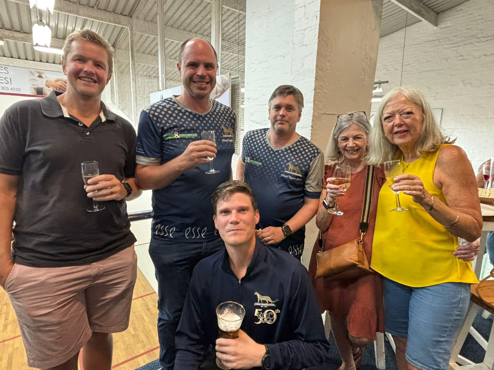 KCC players and supporters gather beside the squash courts after a tournament.